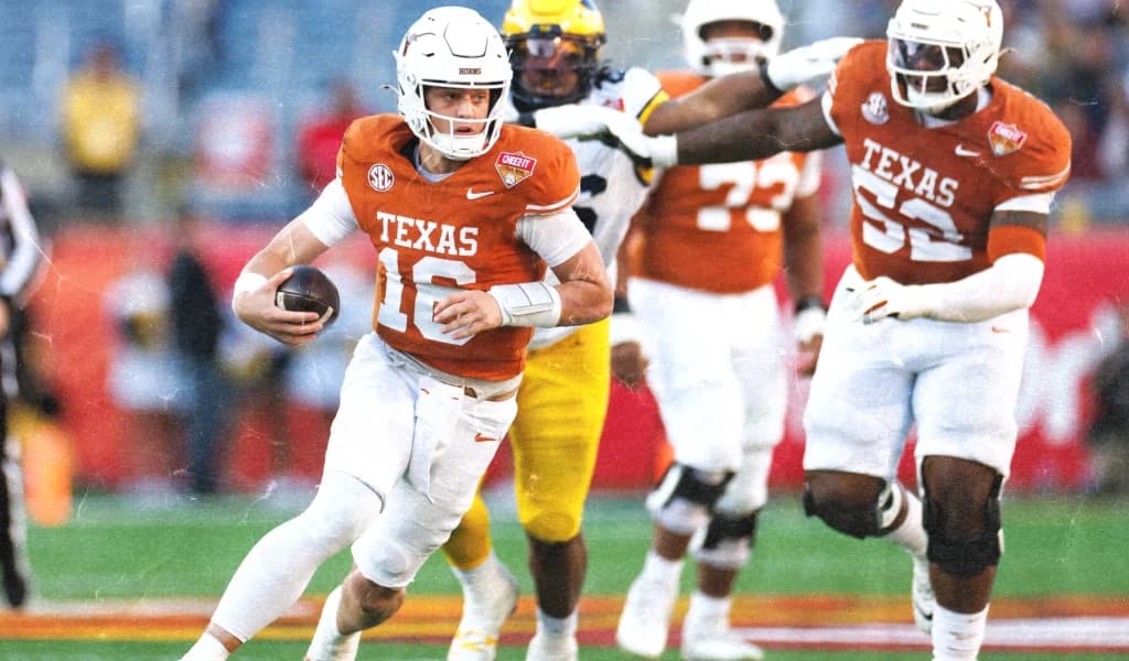 A Texas quarterback in the burnt orange number 16 jersey scrambles with teammates in pursuit.