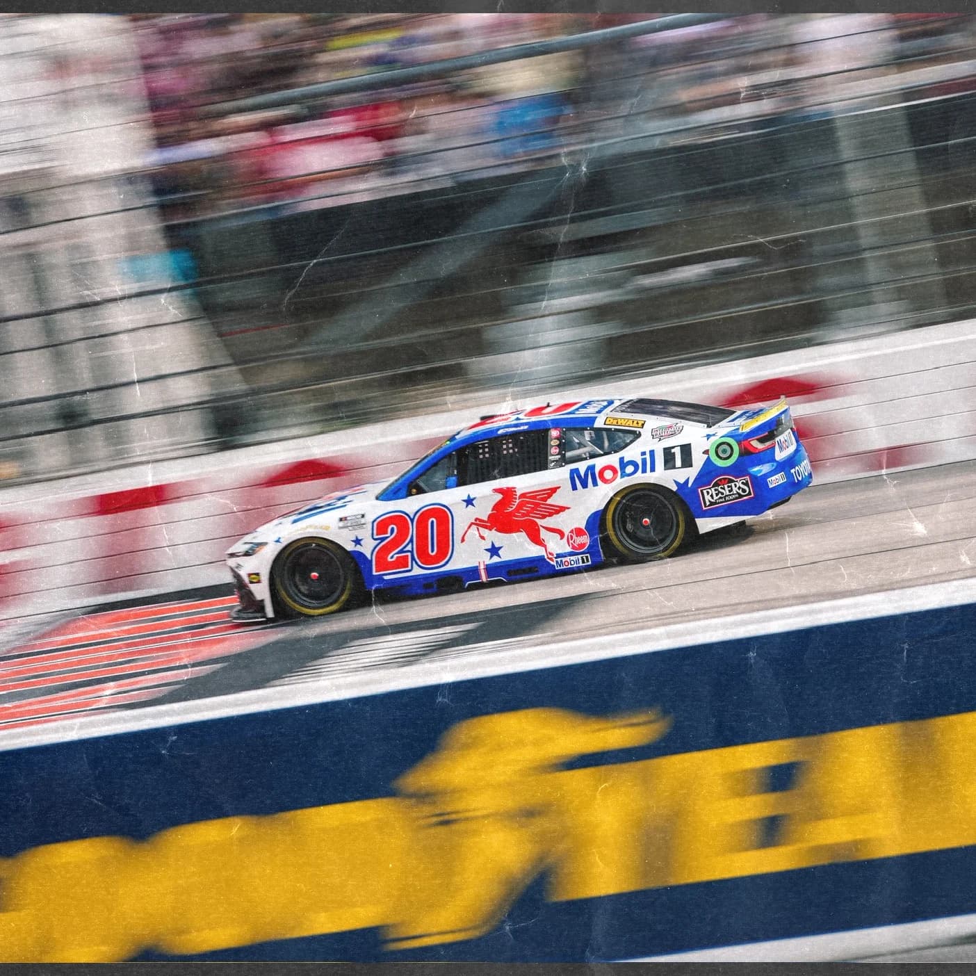 A red white and blue number 20 NASCAR Cup car speeds past at a superspeedway.