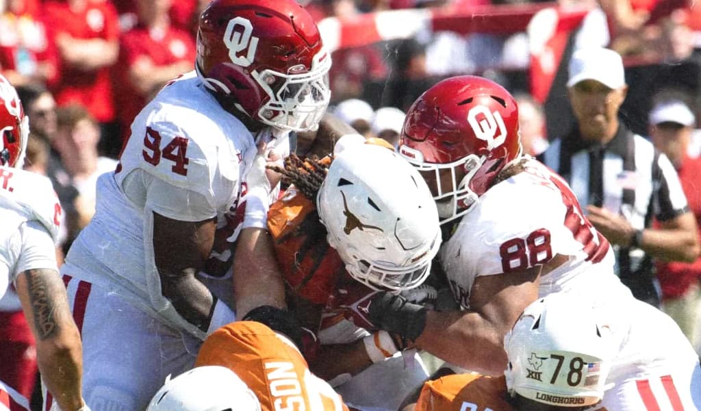 Oklahoma and Texas linemen collide at the line of scrimmage