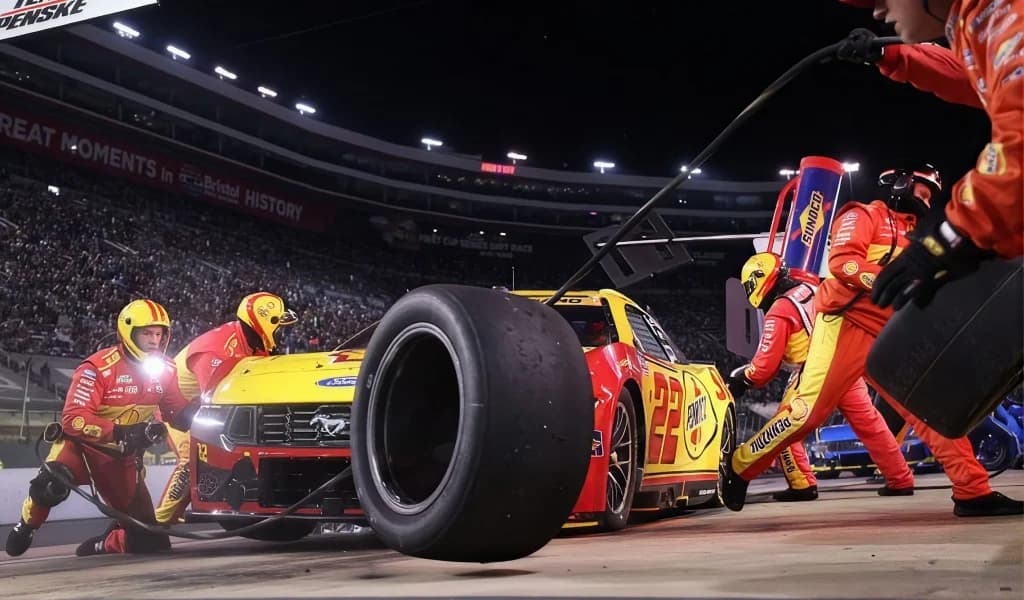 Pit crew services the number 22 car under the lights