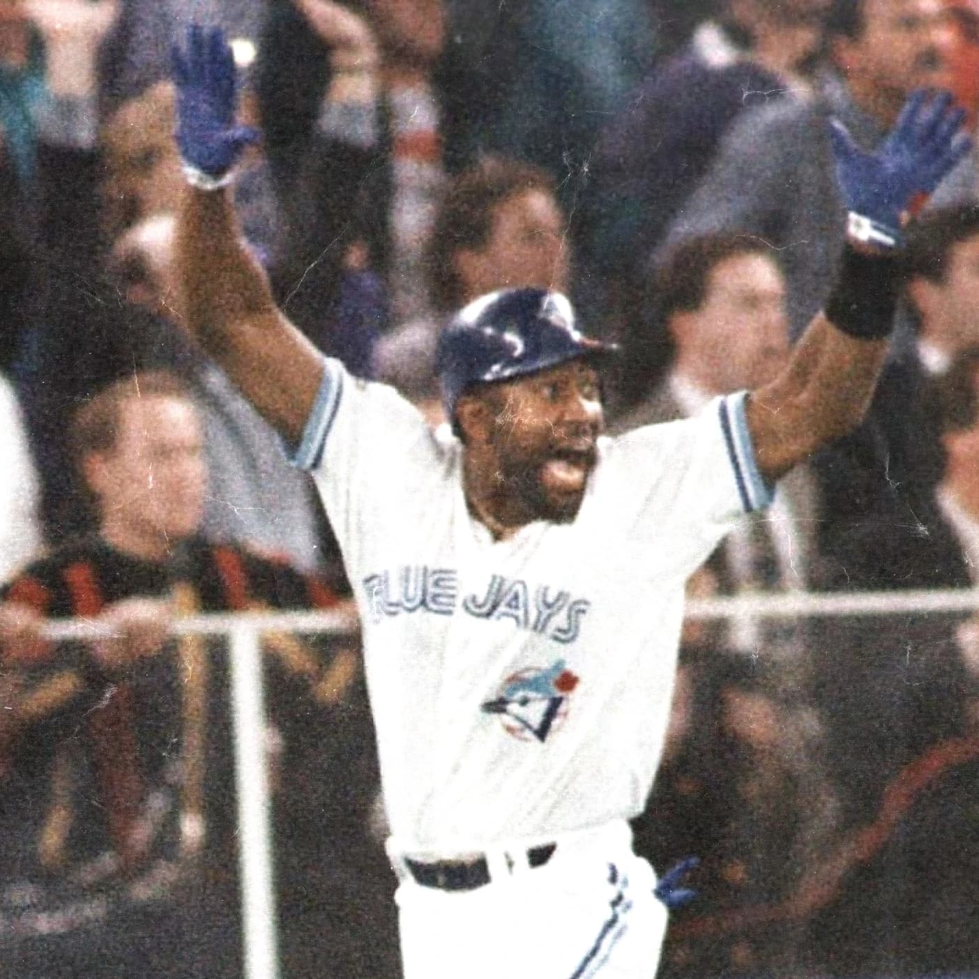 Joe Carter of the Toronto Blue Jays throws his arms up celebrating his World Series home run.