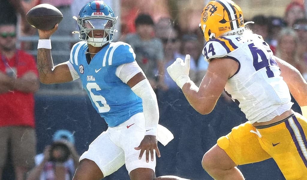 Ole Miss quarterback fires a pass under pressure from an LSU pass rusher in the 2026 Week 3 college football showdown