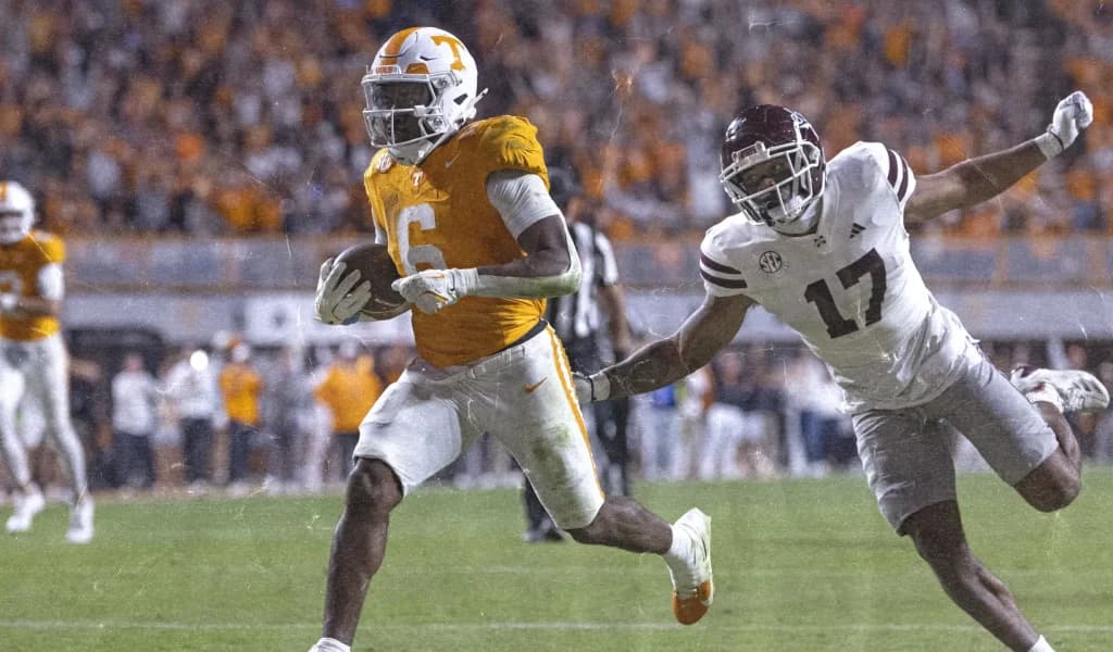 Tennessee Volunteers receiver breaks free from a Mississippi State defender under the lights