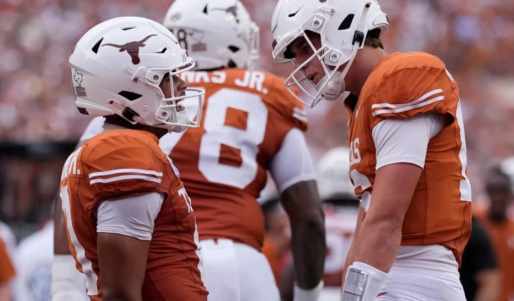Texas Longhorns teammates celebrate a touchdown