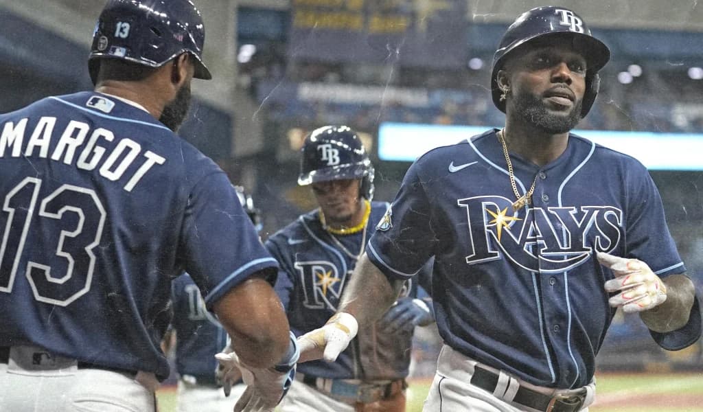 Tampa Bay Rays teammates celebrate in the dugout
