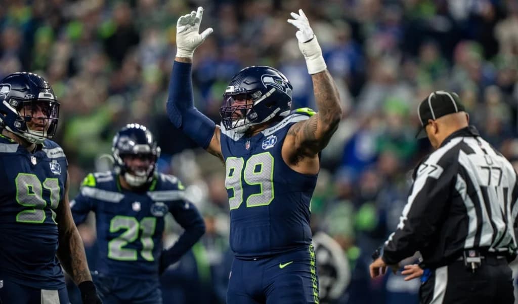 Seattle Seahawks defensive lineman celebrates a stop with his teammates