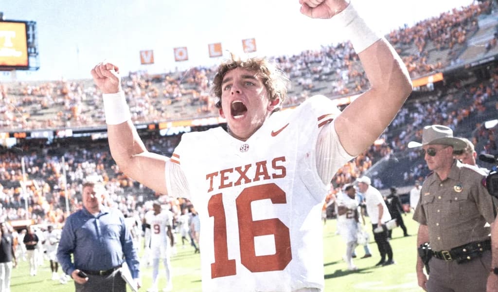 Texas Longhorns quarterback celebrates with fans after a road win