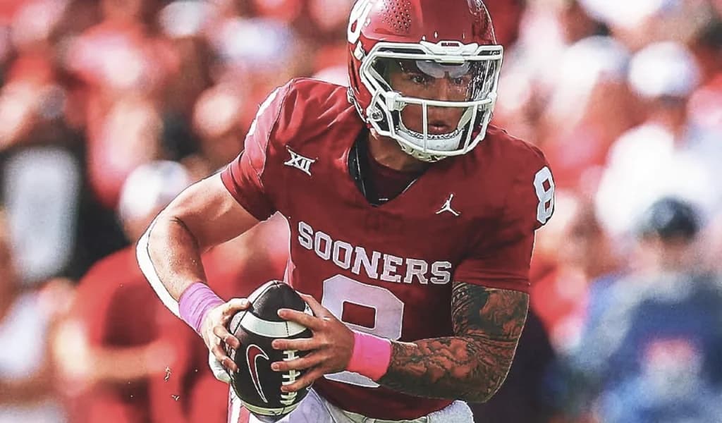 Oklahoma Sooners quarterback tucks the ball and runs